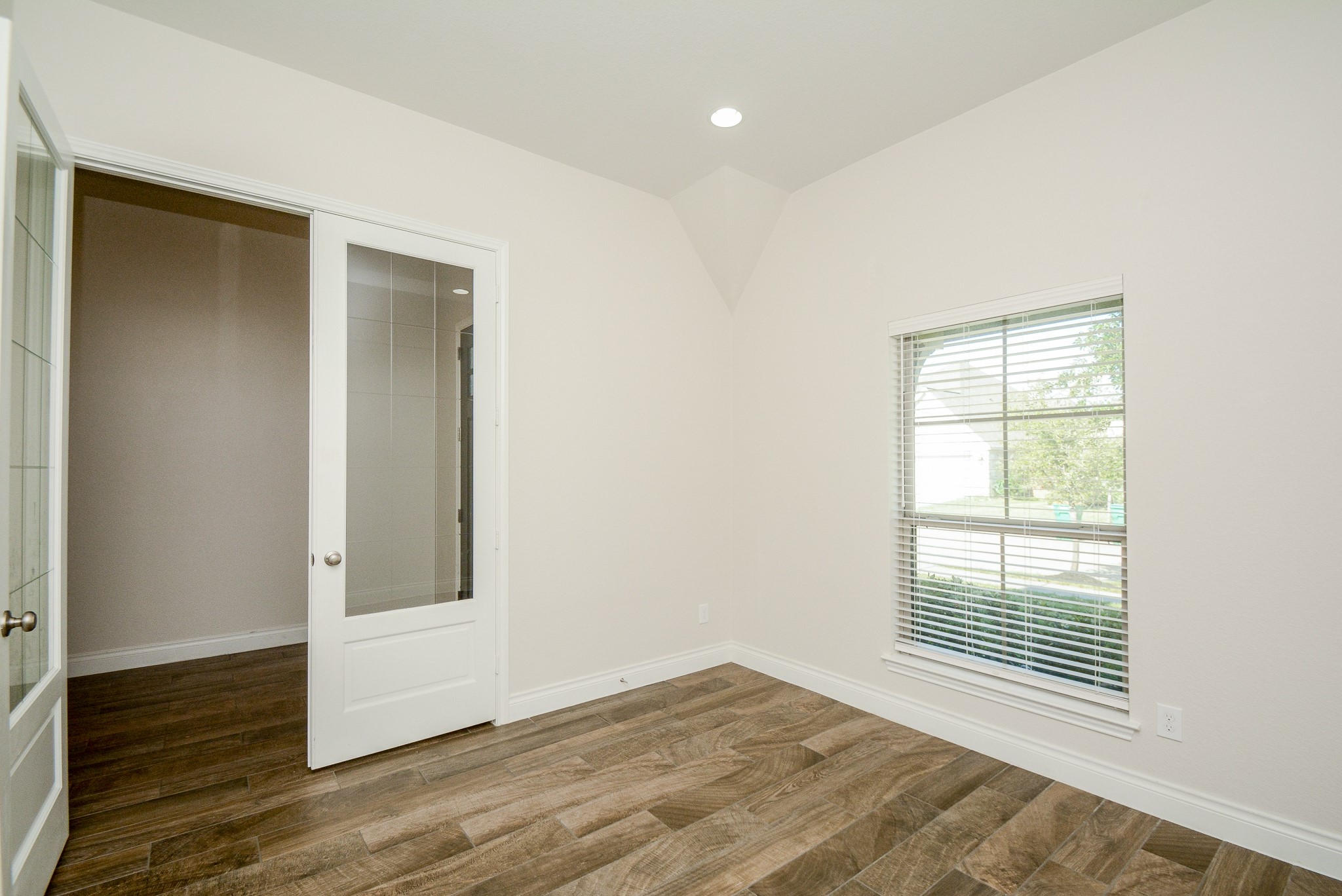 28127 Knight Peak Drive Spring, TX 77386 - Photo 8 of 42 a view of an empty room with wooden floor and a window