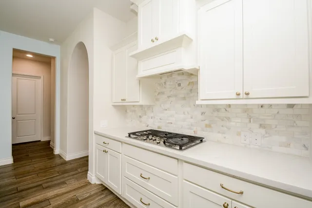 a kitchen with stainless steel appliances a sink stove and refrigerator