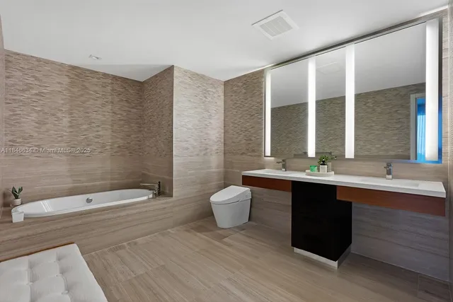 a bathroom with a double vanity sink a large mirror and shower