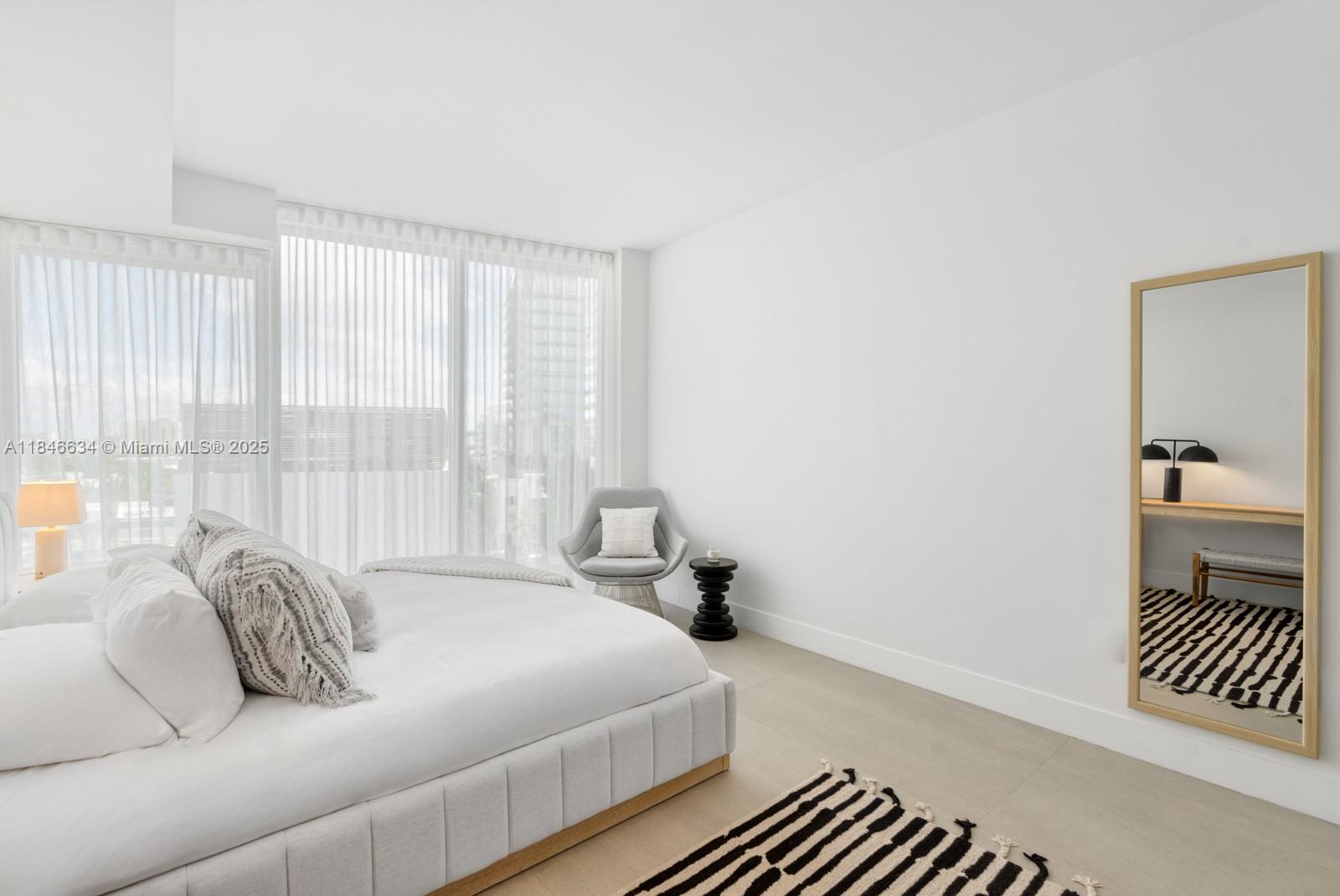 1 Collins Avenue, Unit 605 Miami Beach, FL 33139 - Photo 16 of 33 a bedroom with a bed and a window