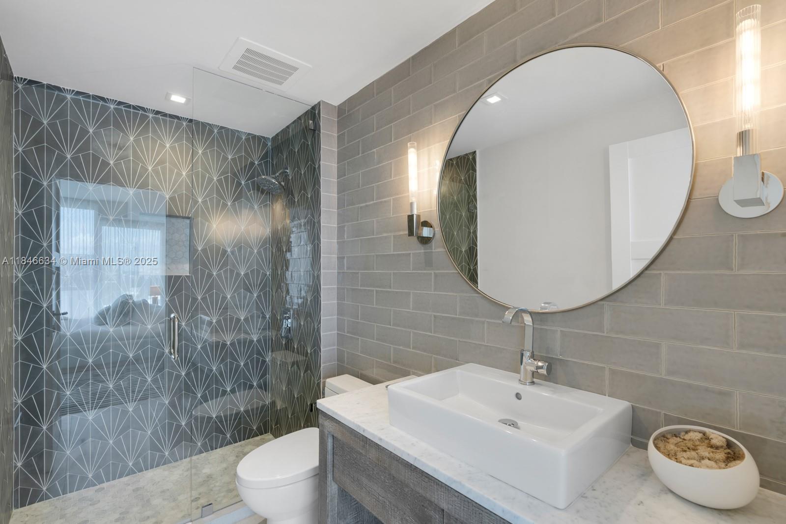 1 Collins Avenue, Unit 605 Miami Beach, FL 33139 - Photo 18 of 33 a bathroom with a sink toilet and shower