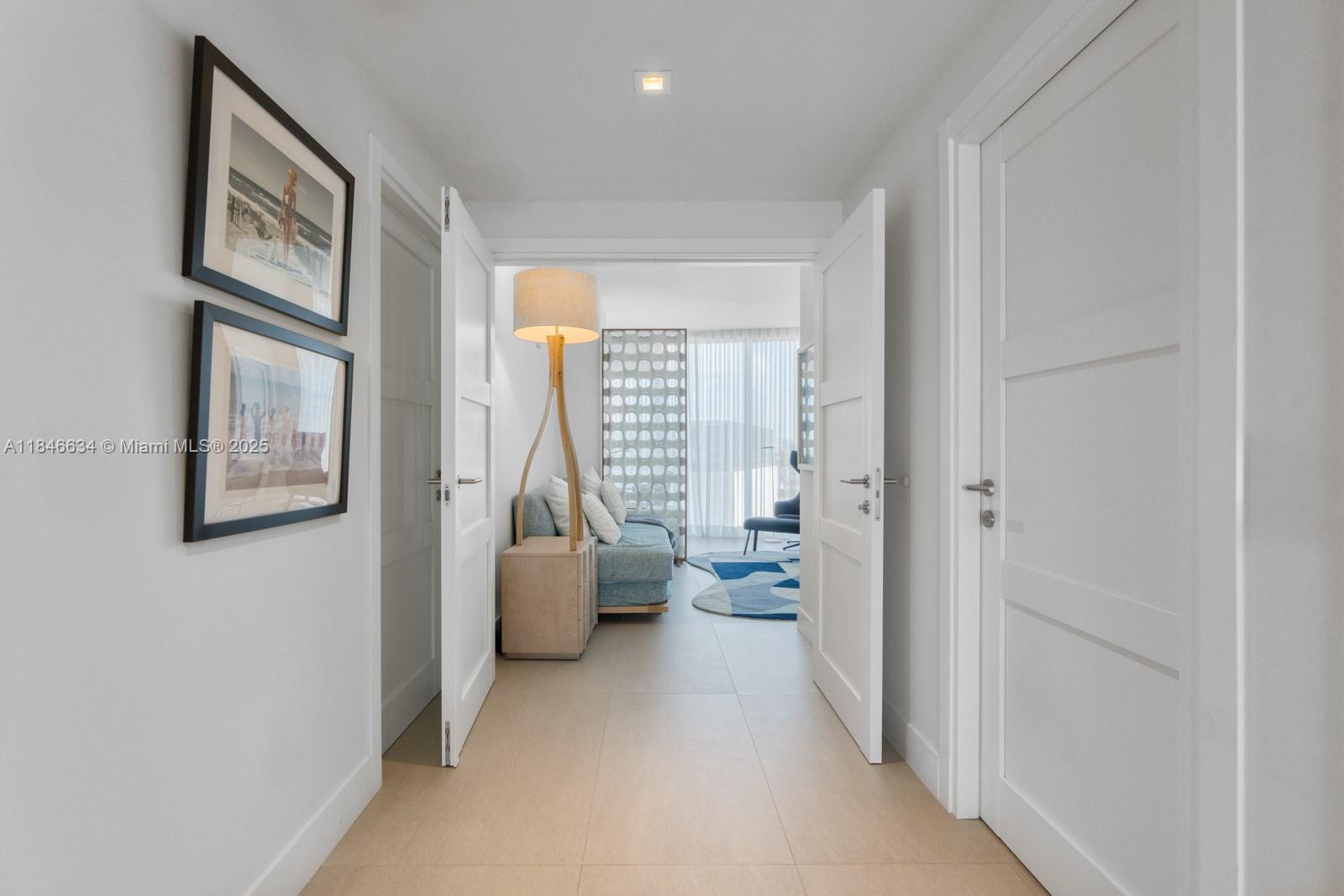 1 Collins Avenue, Unit 605 Miami Beach, FL 33139 - Photo 20 of 33 a living room with furniture and a large window