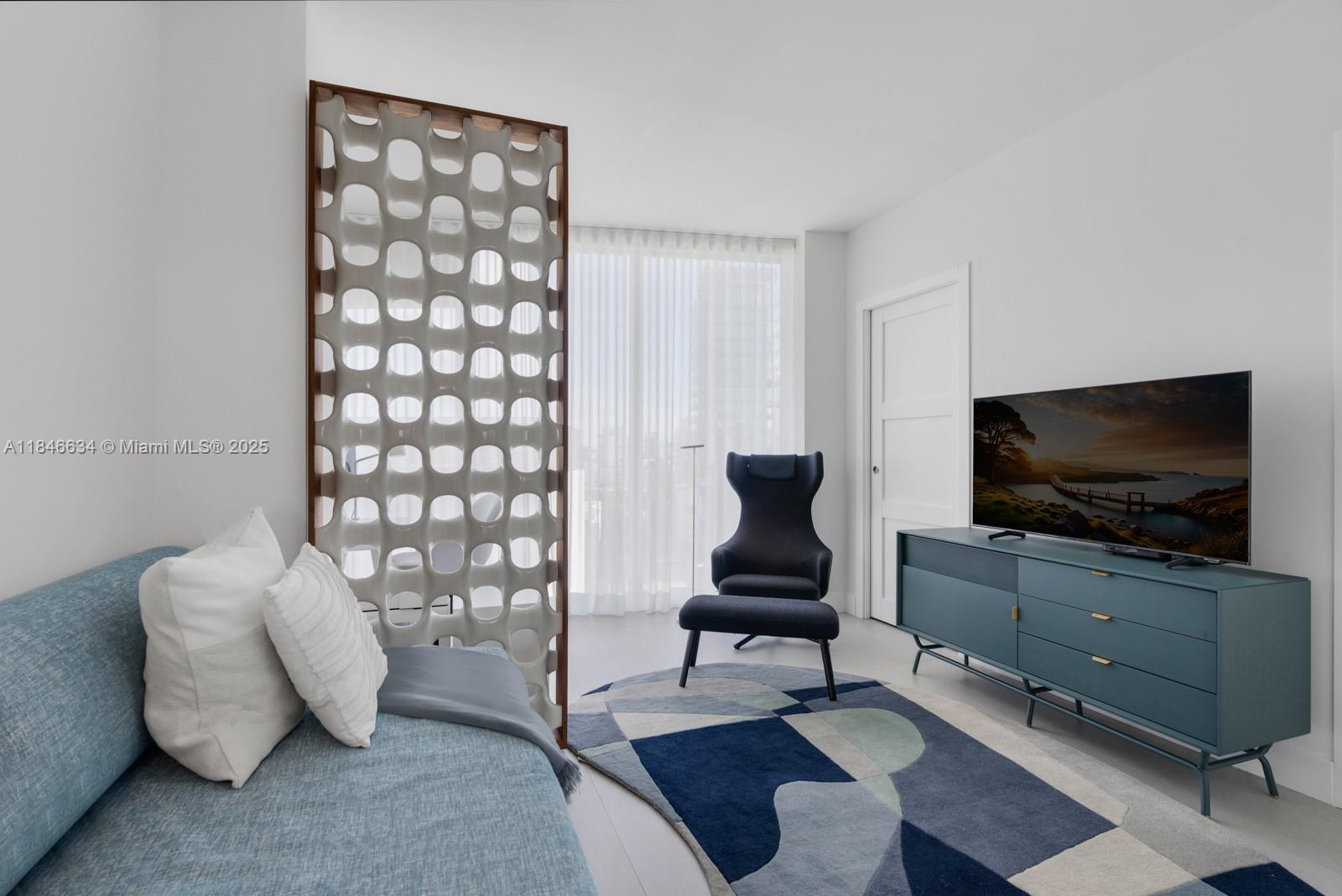 1 Collins Avenue, Unit 605 Miami Beach, FL 33139 - Photo 21 of 33 a living room with furniture and a flat screen tv