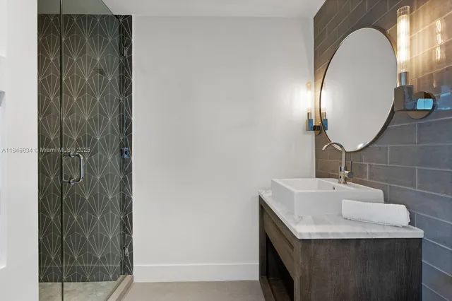 a kitchen with stainless steel appliances kitchen island granite countertop a refrigerator oven a stove and a sink