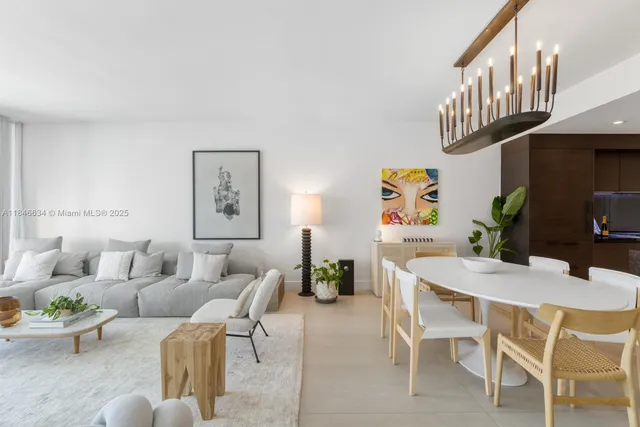 a living room with furniture a rug and a chandelier