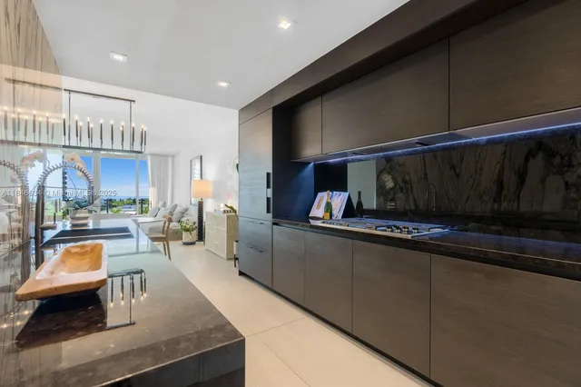 a kitchen with stainless steel appliances kitchen island granite countertop a sink and a stove