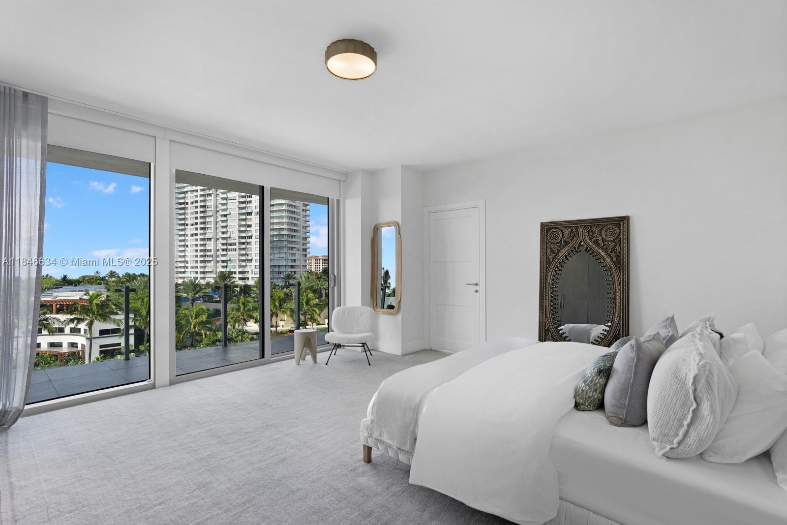 1 Collins Avenue, Unit 605 Miami Beach, FL 33139 - Photo 10 of 33 a bedroom with a bed and a large window
