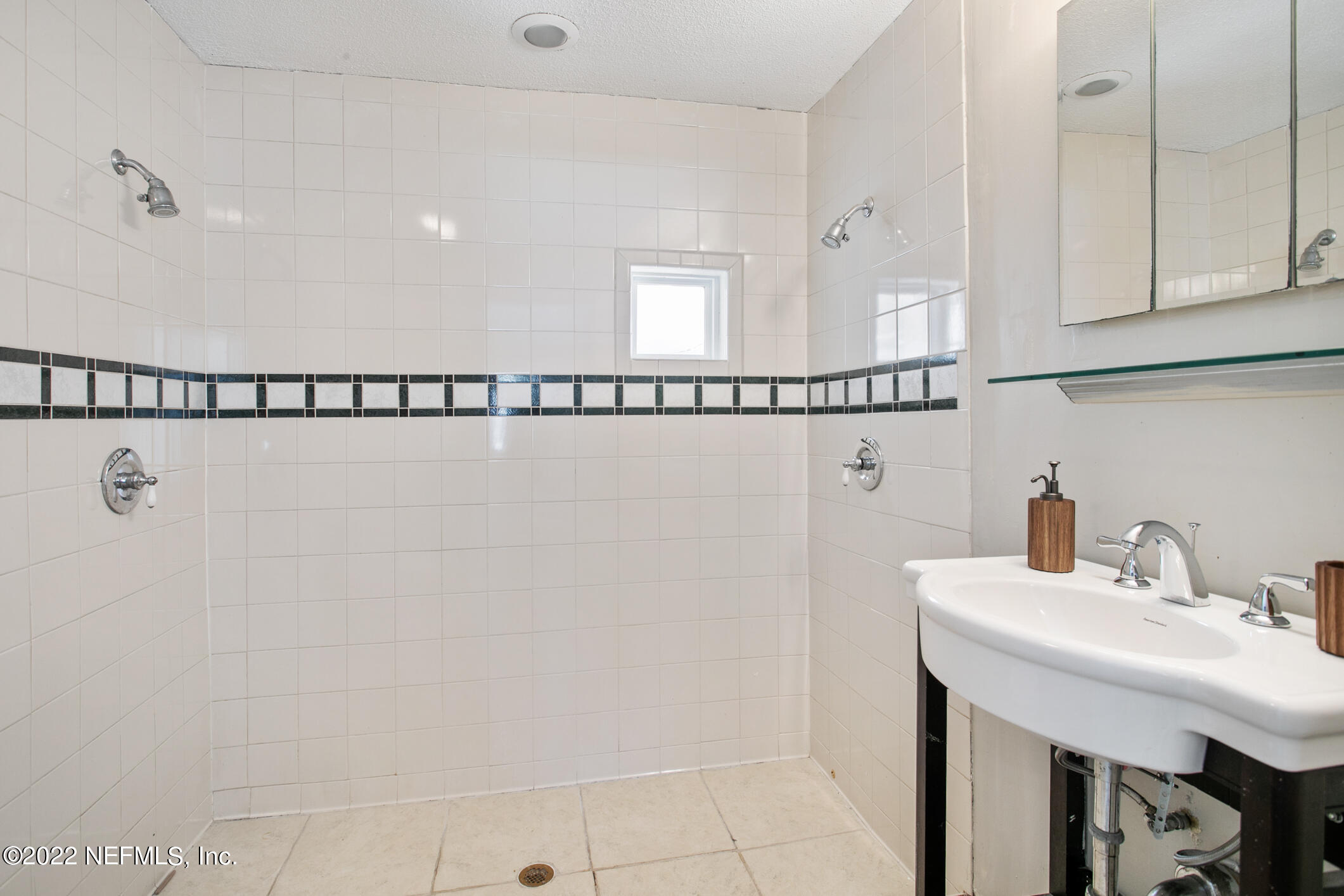 97 Spring Street St. Augustine, FL 32084 - Photo 14 of 18 a bathroom with a sink and a mirror