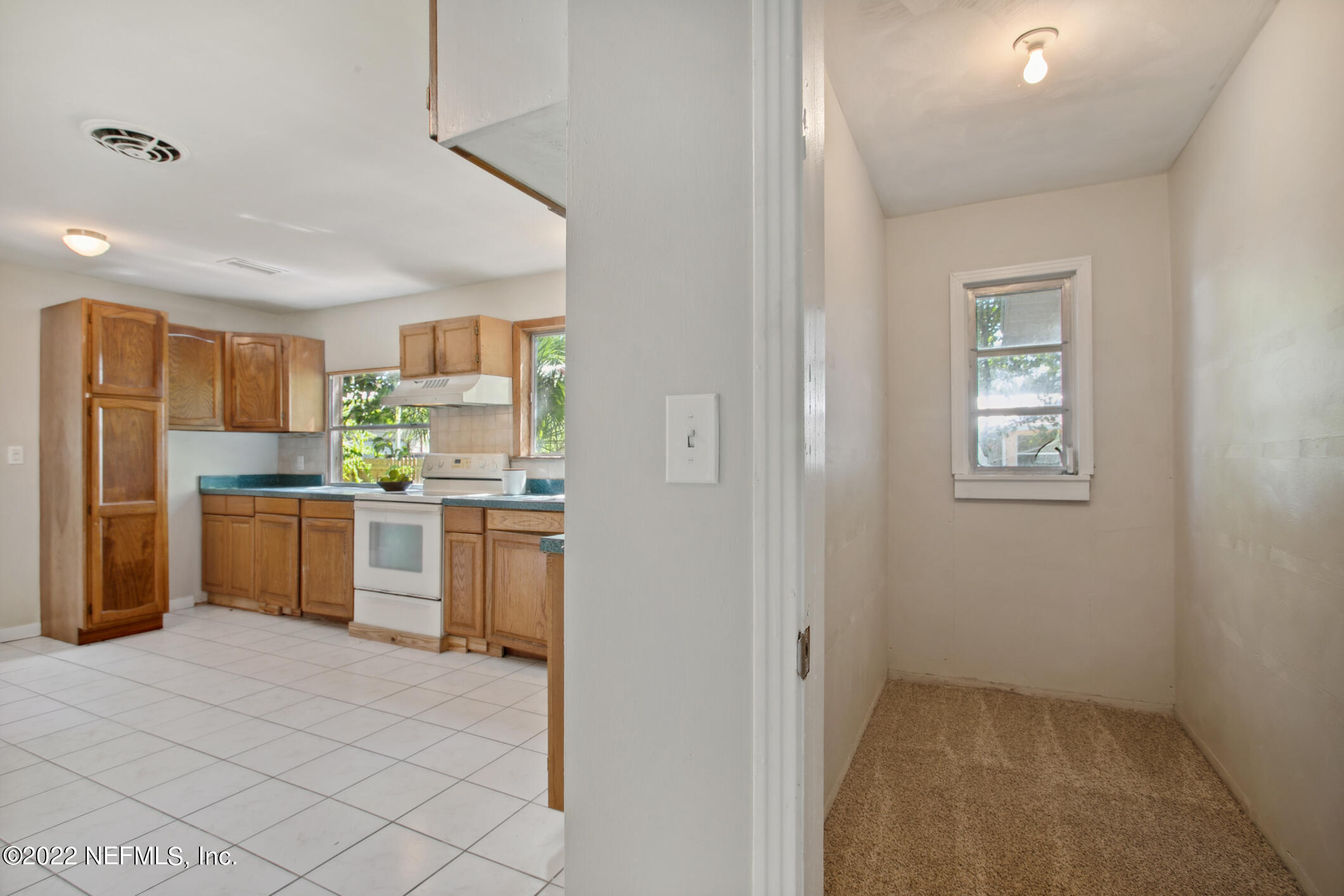 97 Spring Street St. Augustine, FL 32084 - Photo 10 of 18 a kitchen with a refrigerator sink and cabinets