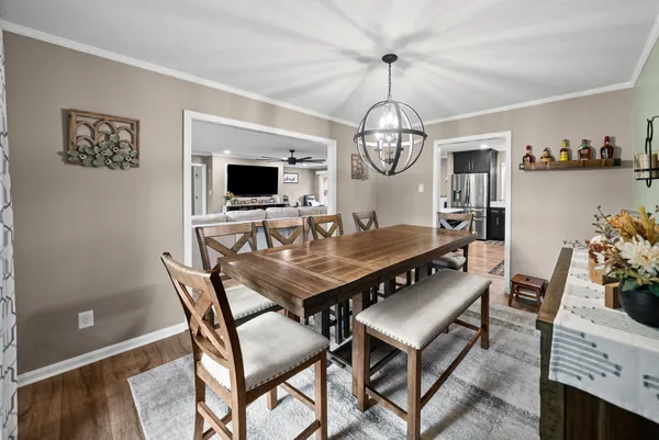 a view of a dining room with furniture and chandelier