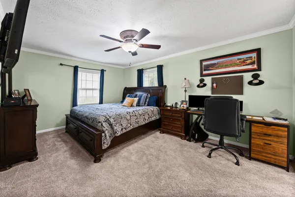 a bedroom with a bed dresser and a window