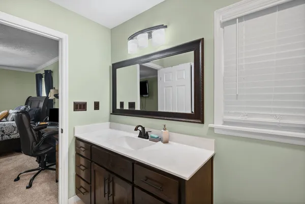 a bathroom with a sink vanity and a mirror