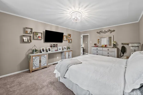 a bedroom with furniture and a flat screen tv