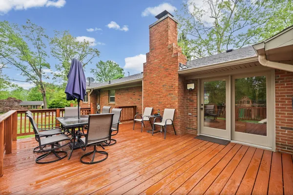 a view of a patio with table and chairs and wooden floor