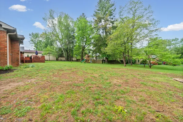 a view of a yard with a house in the background
