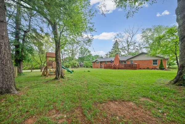 a view of yard with grass and a trees