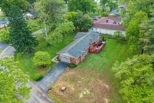 an aerial view of a house with a yard and lake view