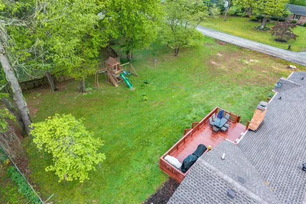 an aerial view of a house with garden space and a street view