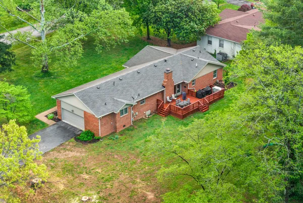 a front view of house with yard and trees