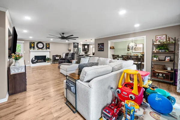 a living room filled with furniture and a flat screen tv