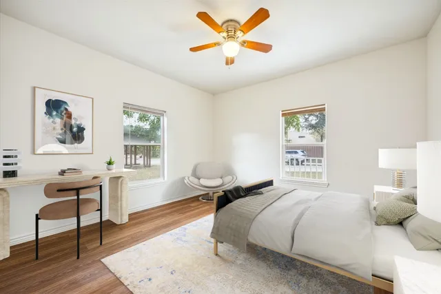 a kitchen with granite countertop stainless steel appliances and wooden floor
