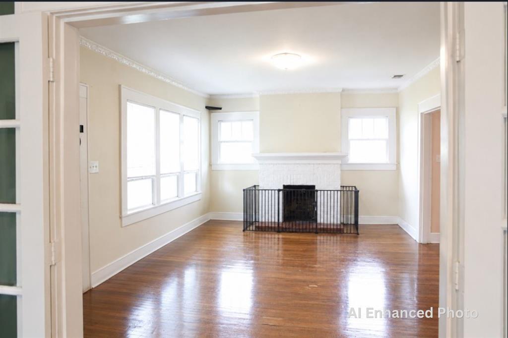 1500 Bonham Street Commerce, TX 75428 - Photo 4 of 29 a living room with a fireplace and a window