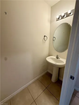 a bathroom with a sink toilet and mirror