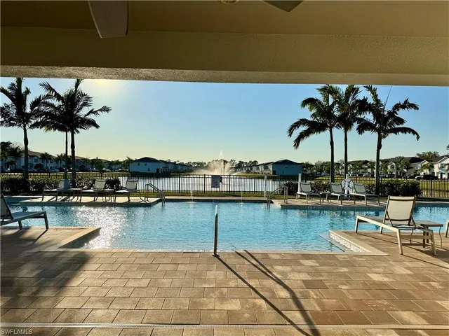 a view of a patio with dining table and chairs