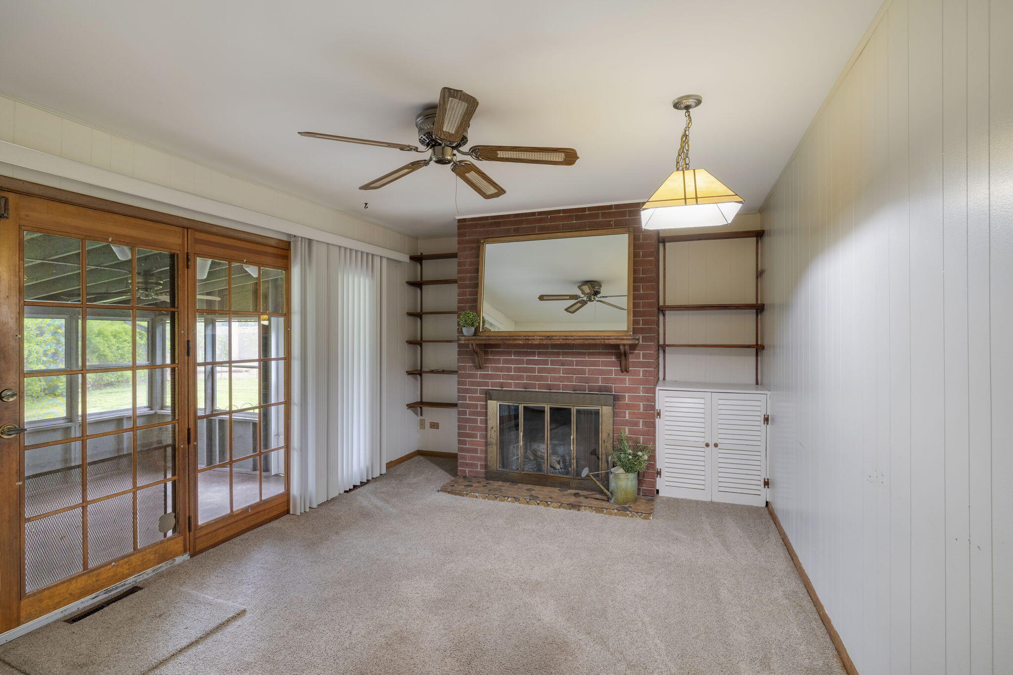218 West 38th Court Griffith, IN 46319 - Photo 10 of 23 a view of empty room with fireplace and fan