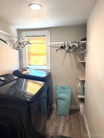 a room with a sink and a wooden floor