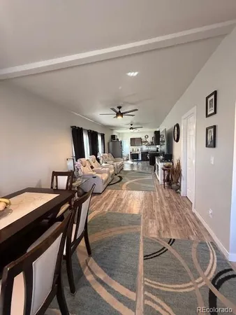 a view of a dining room with furniture and a chandelier