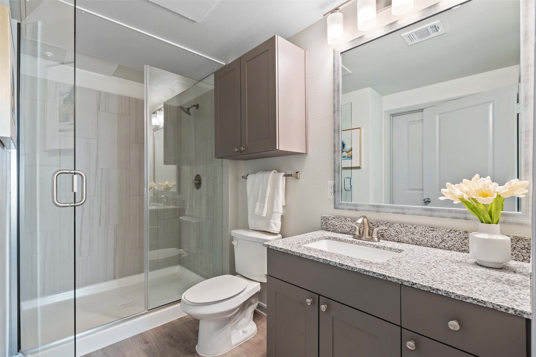 1101 Halsey Drive, Unit 2515 Leander, TX 78641 - Photo 45 of 50 a bathroom with a granite countertop sink a toilet and shower