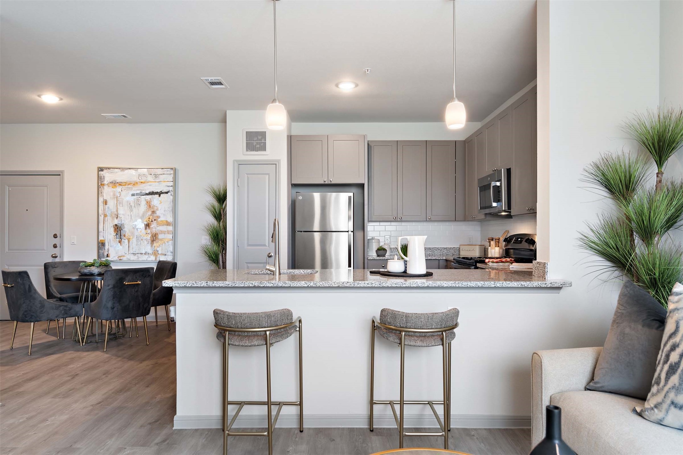 1101 Halsey Drive, Unit 2515 Leander, TX 78641 - Photo 33 of 50 a kitchen with stainless steel appliances granite countertop a kitchen island and chairs in it