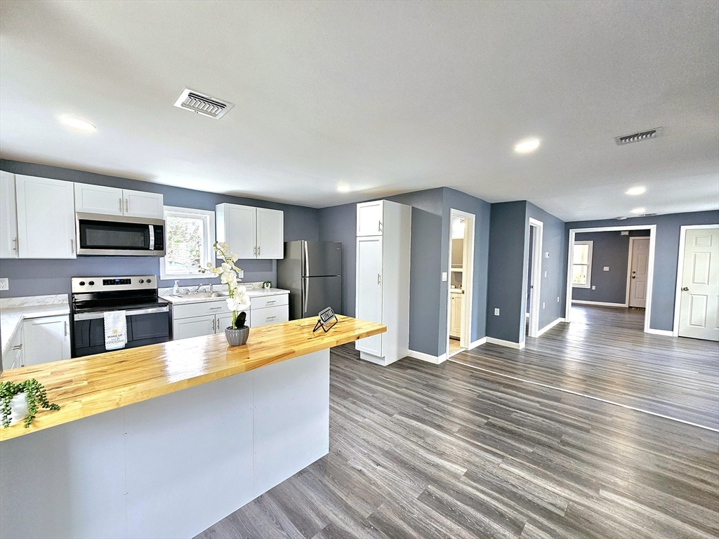 9 Wellington Street Webster, MA 01570 - Photo 1 of 37 a large kitchen with stainless steel appliances granite countertop a large counter top stainless steel appliances and cabinets