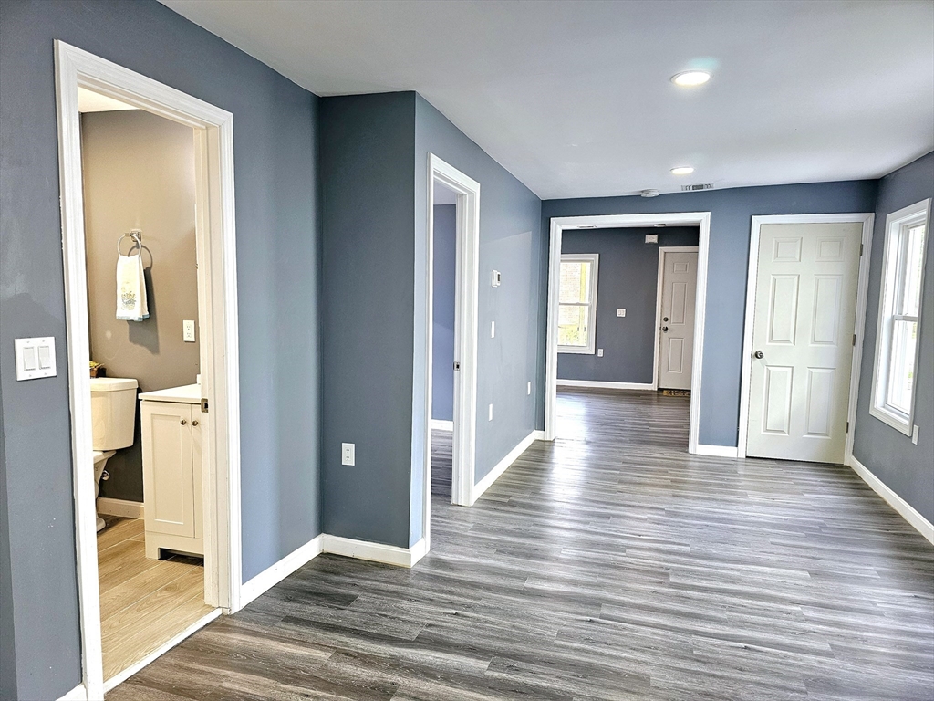 9 Wellington Street Webster, MA 01570 - Photo 13 of 37 a view of a hallway with wooden floor and a bathroom