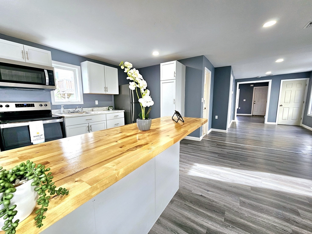 9 Wellington Street Webster, MA 01570 - Photo 2 of 37 a large kitchen with kitchen island a sink stainless steel appliances and cabinets