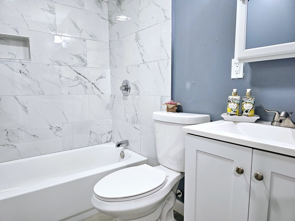 9 Wellington Street Webster, MA 01570 - Photo 25 of 37 a bathroom with a sink a toilet and bathtub