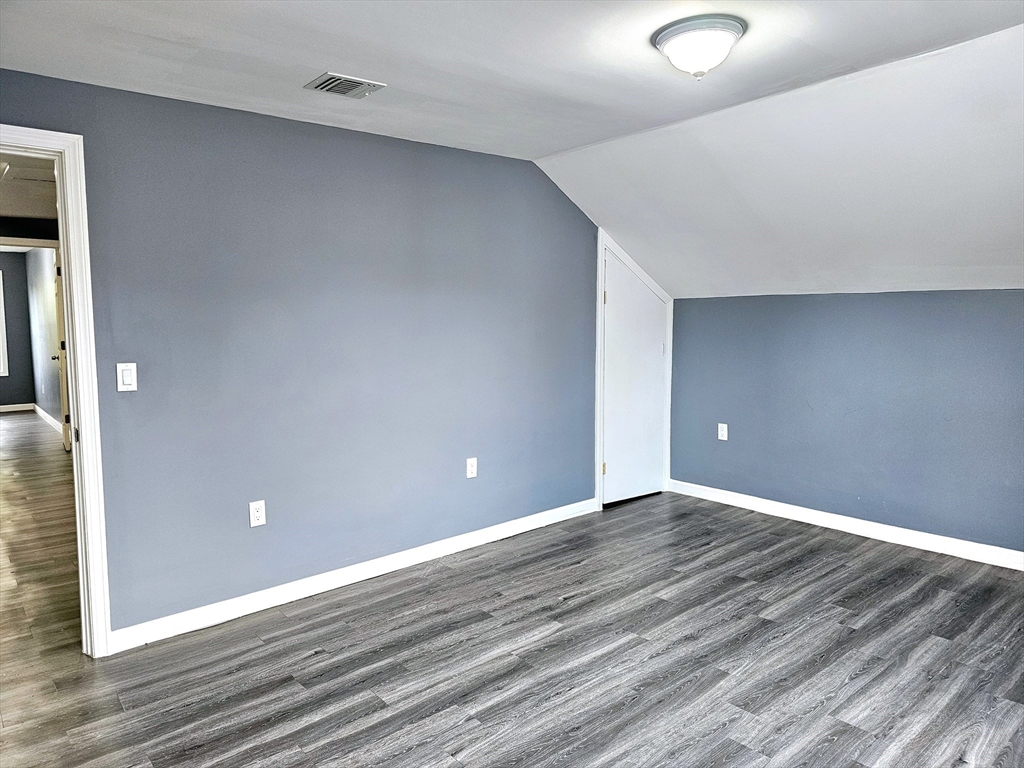 9 Wellington Street Webster, MA 01570 - Photo 26 of 37 a view of an empty room with wooden floor