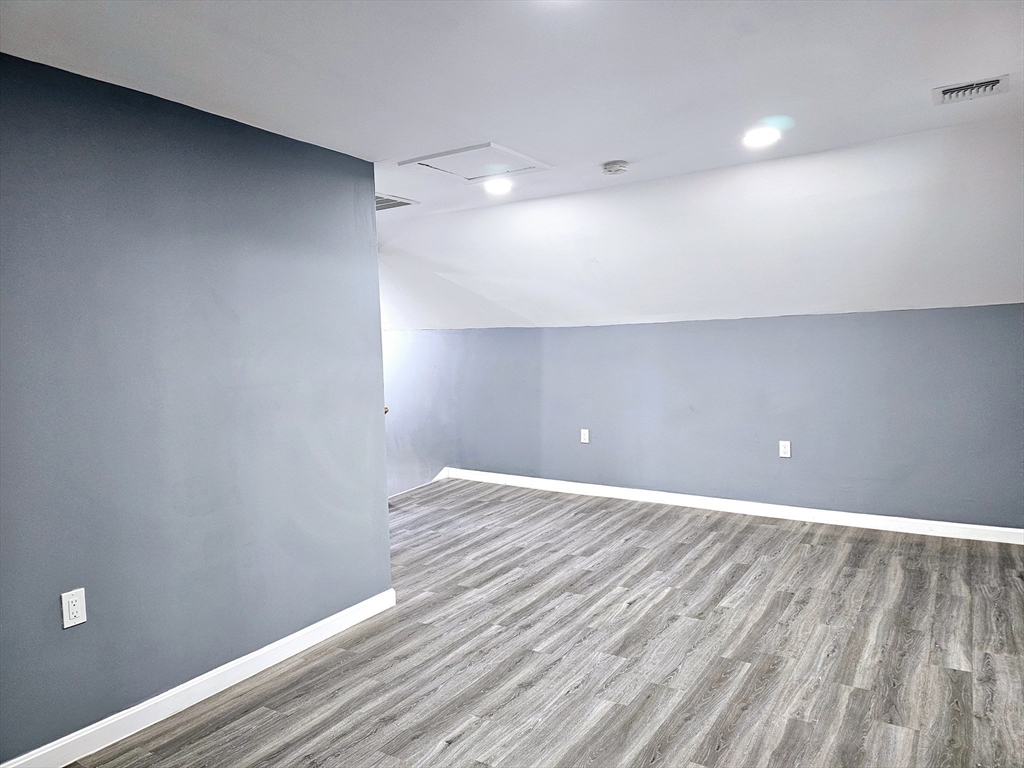 9 Wellington Street Webster, MA 01570 - Photo 27 of 37 a view of an empty room with wooden floor
