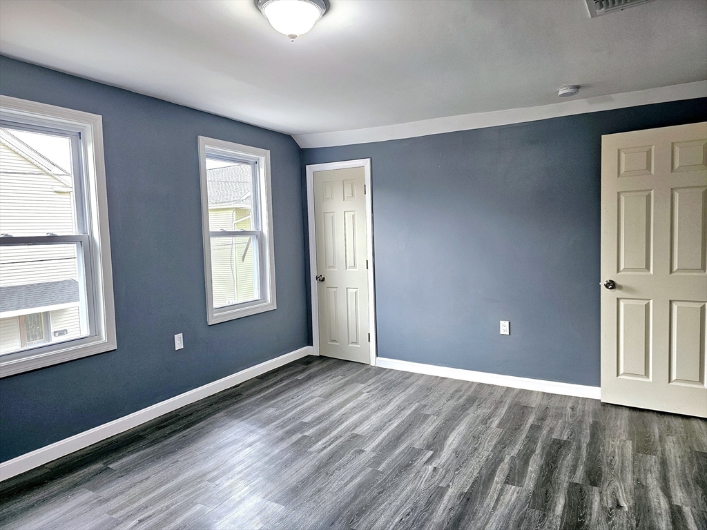 9 Wellington Street Webster, MA 01570 - Photo 32 of 37 a view of an empty room with wooden floor and a window