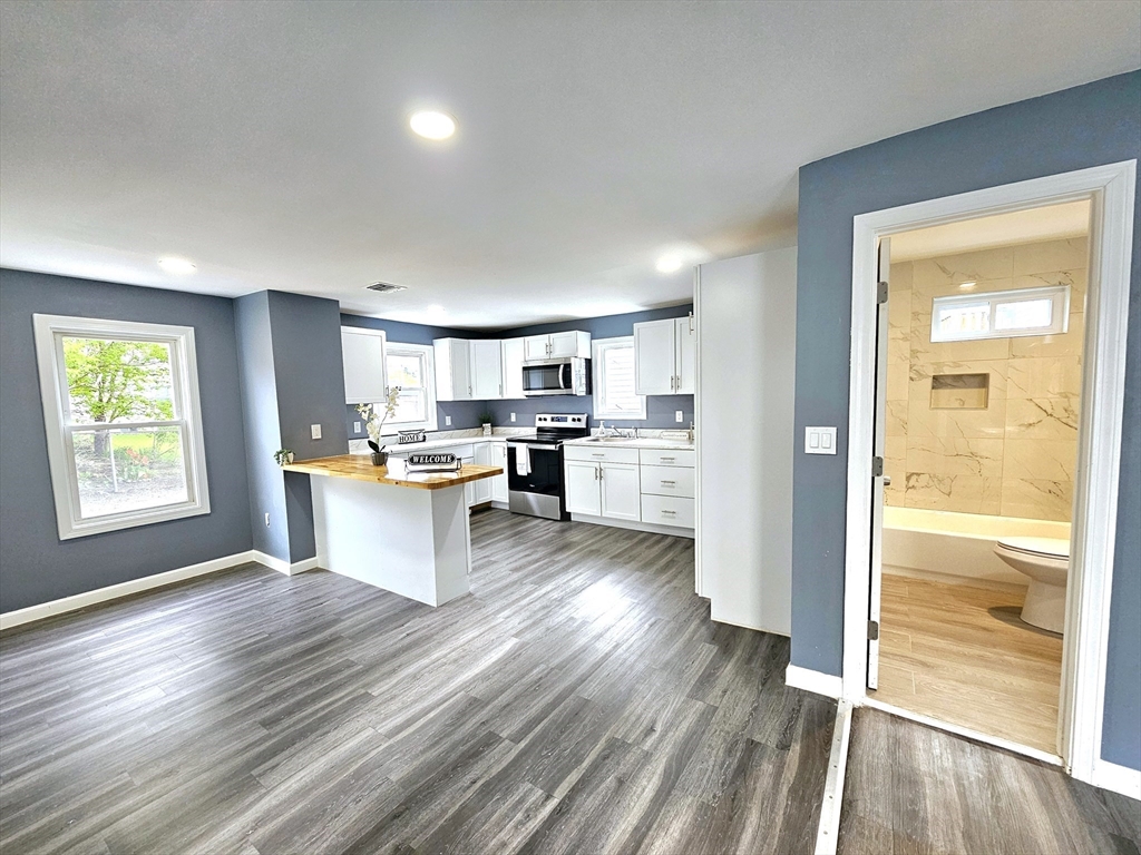 9 Wellington Street Webster, MA 01570 - Photo 4 of 37 a open kitchen with white cabinets and wooden floor