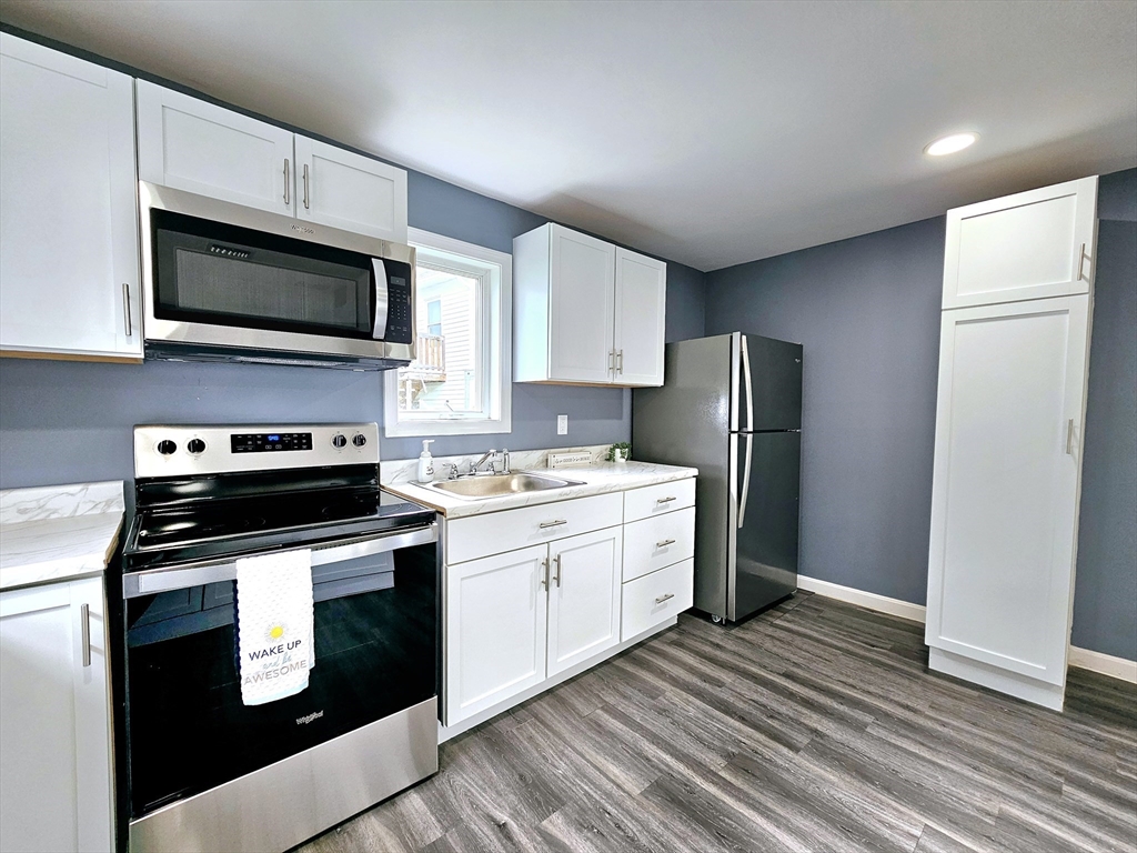 9 Wellington Street Webster, MA 01570 - Photo 8 of 37 a kitchen with granite countertop a refrigerator stove and microwave