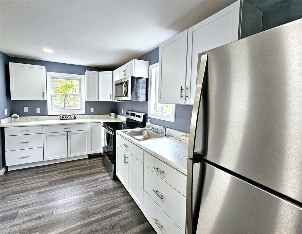 9 Wellington Street Webster, MA 01570 - Photo 9 of 37 a kitchen with stainless steel appliances a refrigerator sink and cabinets
