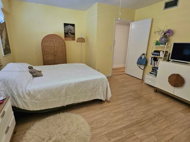 a bedroom with a bed and cabinets