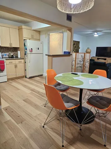a view of kitchen with cabinets and wooden floor