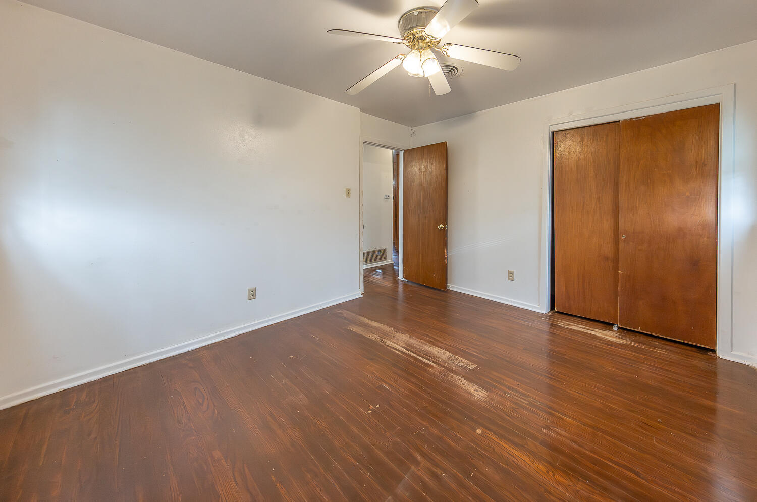 2613 48th Street Lubbock, TX 79413 - Photo 11 of 22 an empty room with wooden floor closet and windows