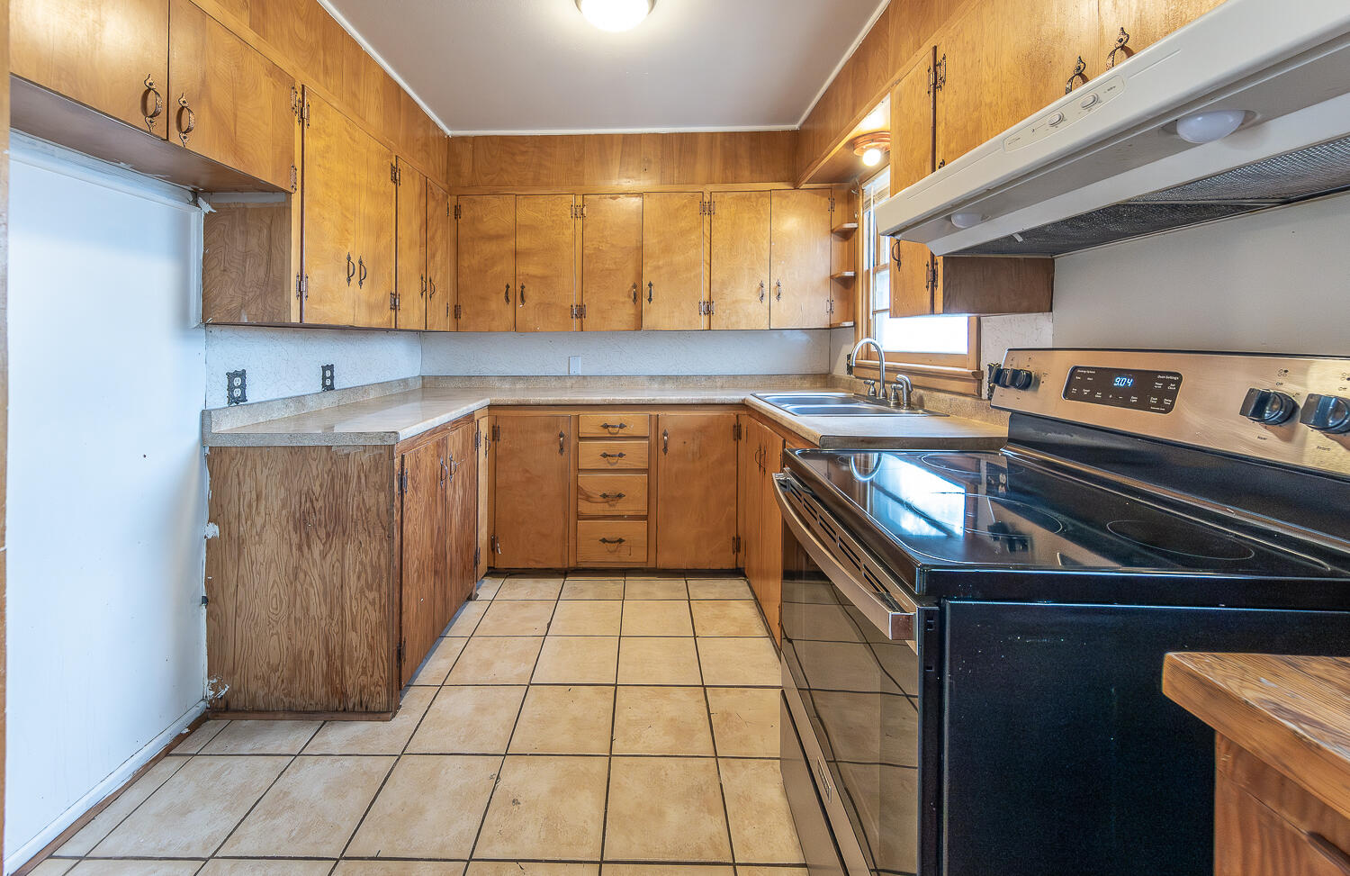 2613 48th Street Lubbock, TX 79413 - Photo 3 of 22 a kitchen with a sink a stove top oven and cabinets