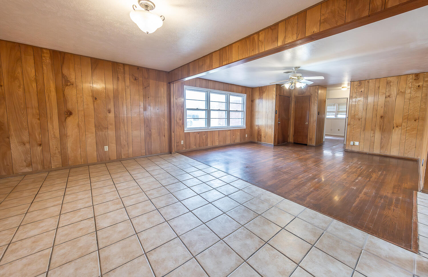2613 48th Street Lubbock, TX 79413 - Photo 6 of 22 an empty room with windows and fan