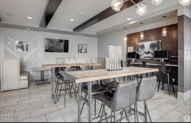 a lobby with furniture and a flat screen tv