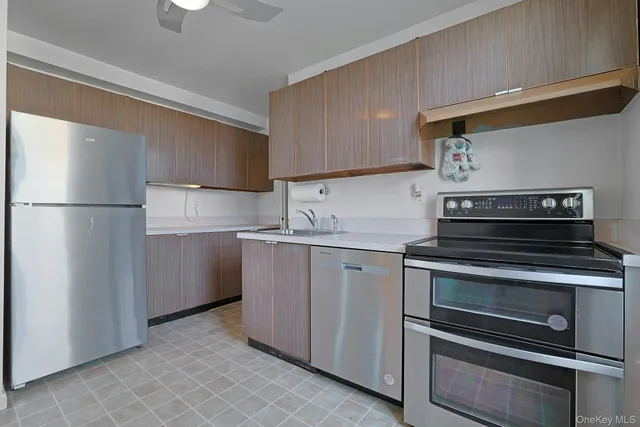a kitchen with appliances a sink and a refrigerator